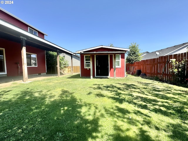 view of outdoor structure featuring a lawn