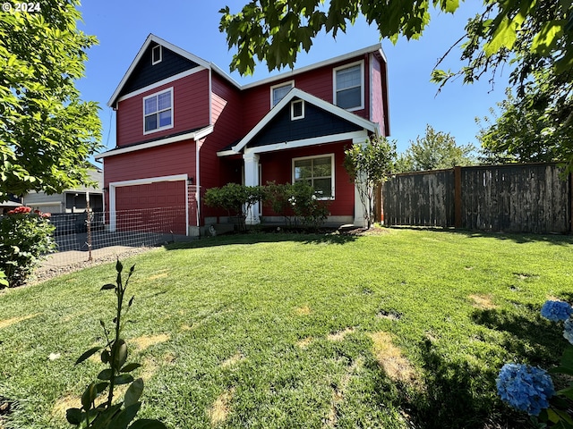 view of front of home with a garage and a front yard