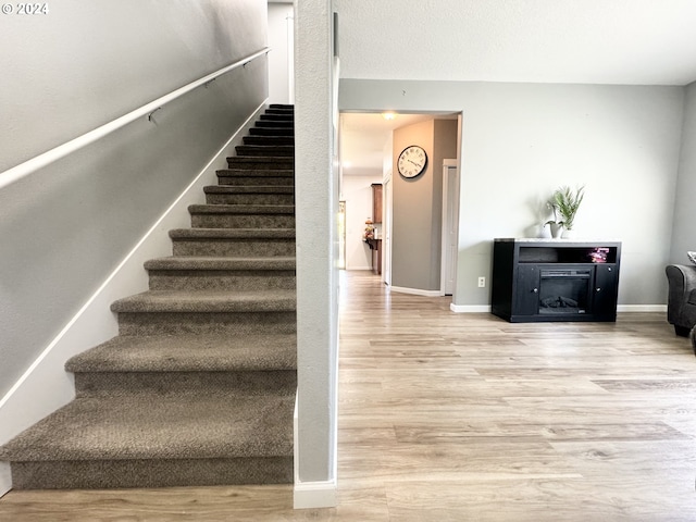 staircase with wood-type flooring