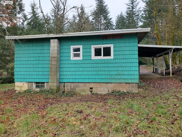 view of side of home with a carport