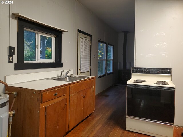 kitchen featuring electric water heater and dark hardwood / wood-style floors