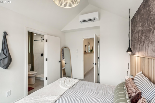 bedroom featuring a wall unit AC, ensuite bathroom, and lofted ceiling