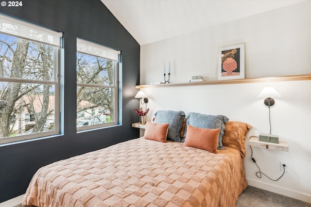 bedroom with carpet floors and lofted ceiling