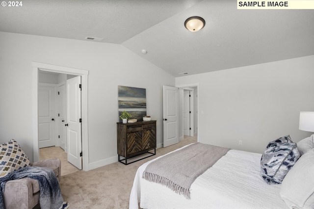 bedroom featuring light colored carpet and lofted ceiling