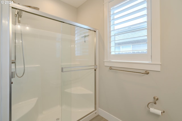 bathroom with a shower with shower door