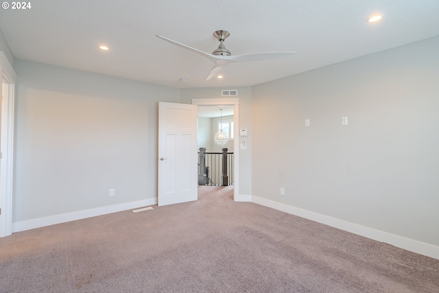 unfurnished room featuring light carpet and ceiling fan