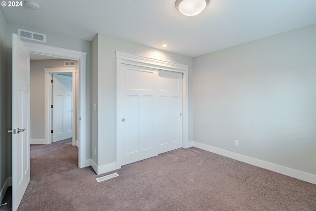 unfurnished bedroom featuring a closet and carpet