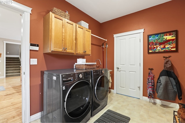 laundry area with cabinets and washing machine and dryer