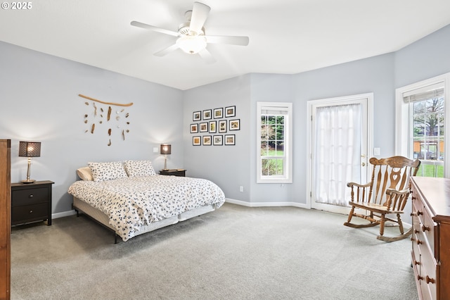 carpeted bedroom featuring multiple windows and ceiling fan