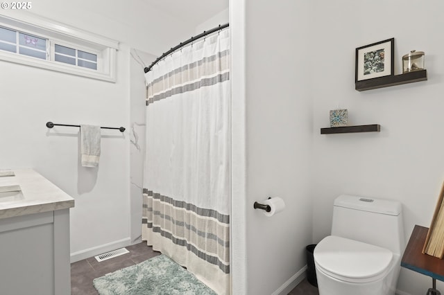 bathroom featuring tile patterned floors, vanity, curtained shower, and toilet