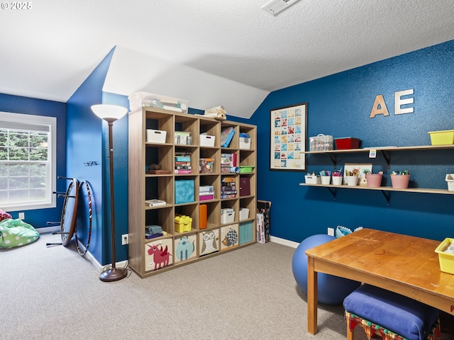 recreation room with a textured ceiling, carpet, and lofted ceiling