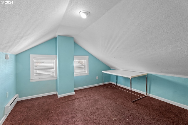 bonus room featuring baseboard heating, dark colored carpet, lofted ceiling, and a textured ceiling