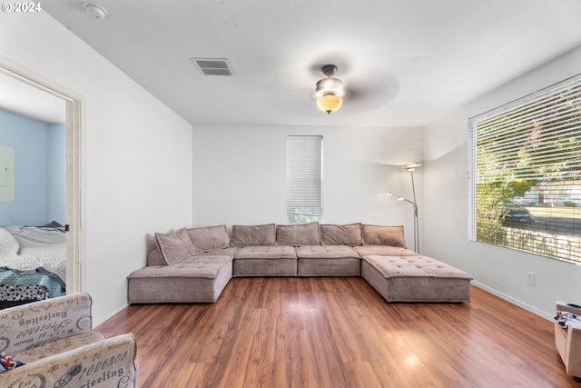 living room with dark hardwood / wood-style floors and ceiling fan