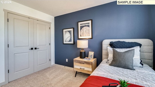 bedroom with a closet, carpet, and baseboards