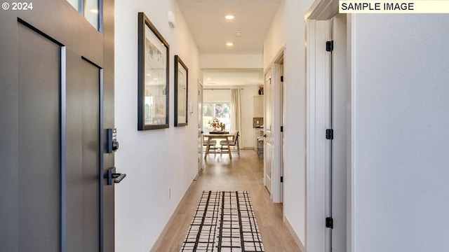 hall with light wood-type flooring and recessed lighting