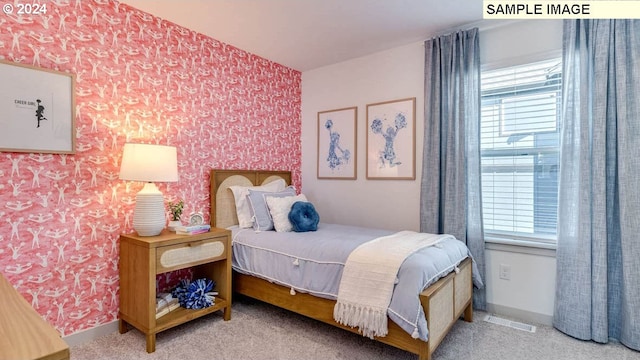 carpeted bedroom featuring visible vents, baseboards, and wallpapered walls