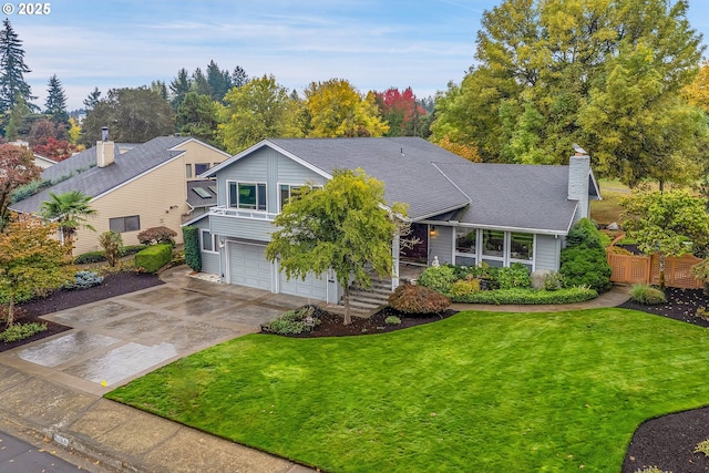 view of front of property with a front yard and a garage