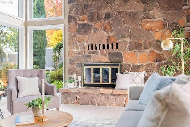 interior space with a towering ceiling and a stone fireplace