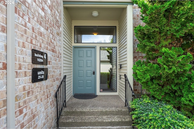 property entrance with brick siding