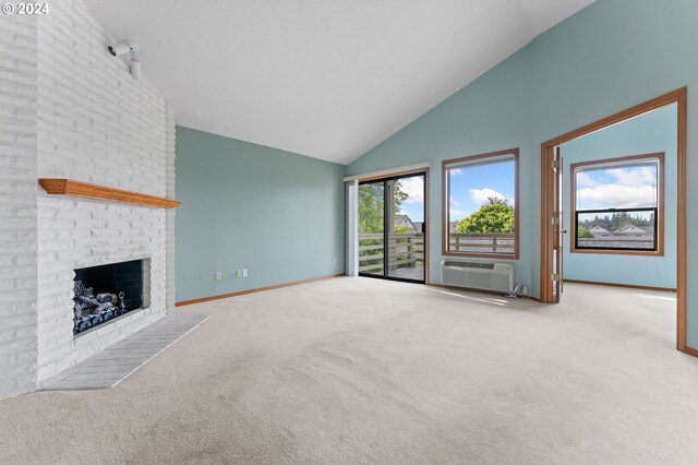 unfurnished living room with light colored carpet, high vaulted ceiling, a brick fireplace, and brick wall