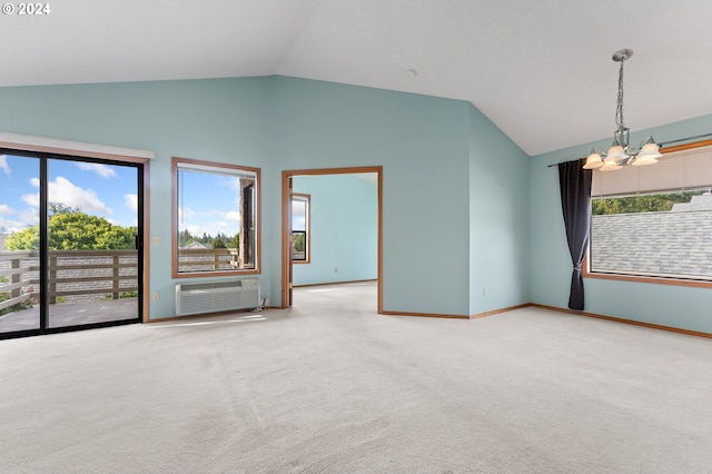 unfurnished room featuring carpet floors, an inviting chandelier, vaulted ceiling, and a wall mounted AC