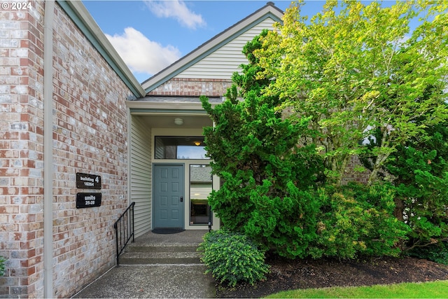 entrance to property with brick siding