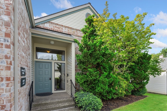 property entrance featuring brick siding