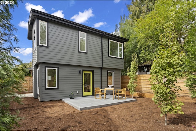 back of property featuring a wooden deck