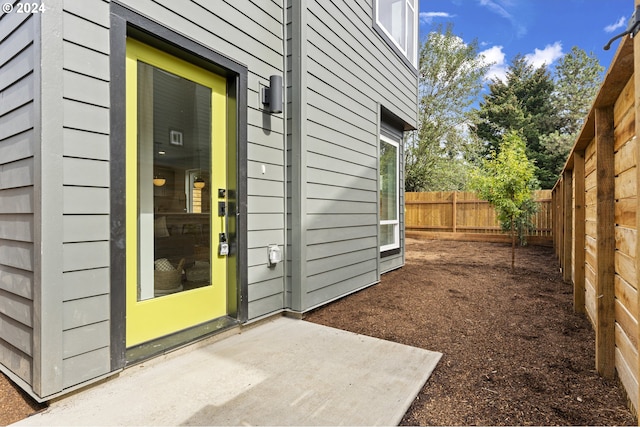 view of exterior entry featuring a patio area