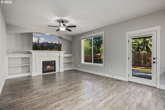 unfurnished living room with light hardwood / wood-style floors and ceiling fan