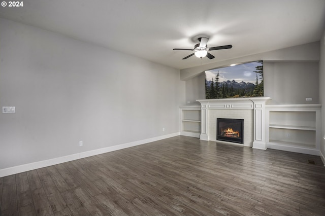 unfurnished living room with a fireplace, dark hardwood / wood-style floors, and ceiling fan