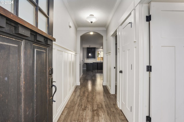 corridor with ornamental molding and dark hardwood / wood-style flooring