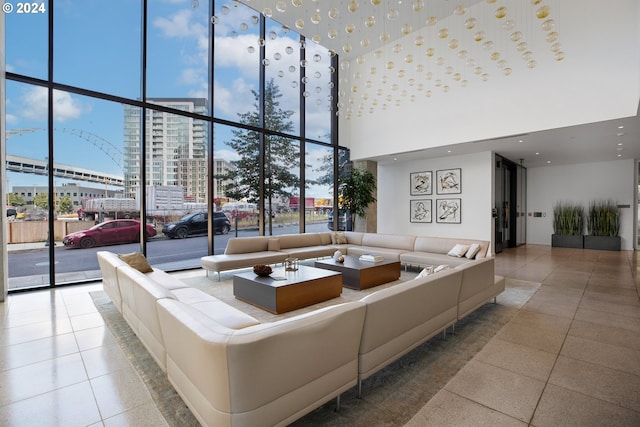 unfurnished living room with a high ceiling and a wall of windows