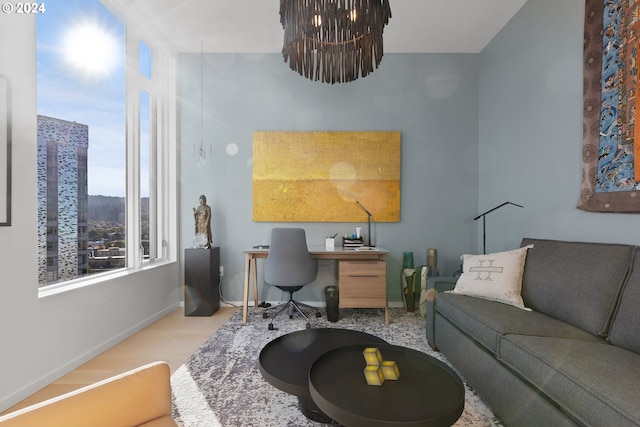 home office featuring light hardwood / wood-style flooring and a chandelier