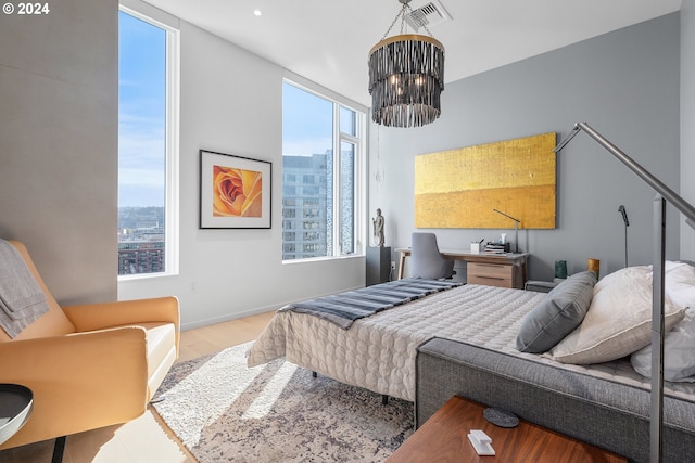 bedroom with a notable chandelier and light hardwood / wood-style floors