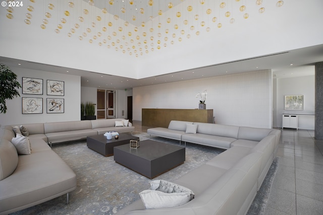 living room with radiator heating unit and a high ceiling