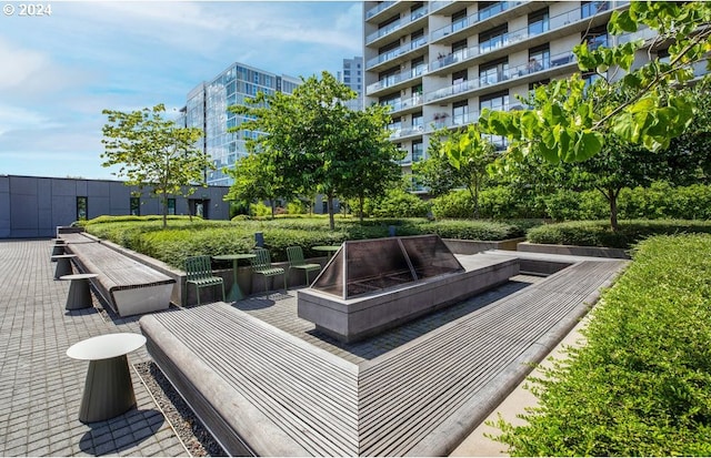 view of home's community featuring a patio area and a fire pit