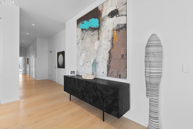 hallway with light hardwood / wood-style flooring