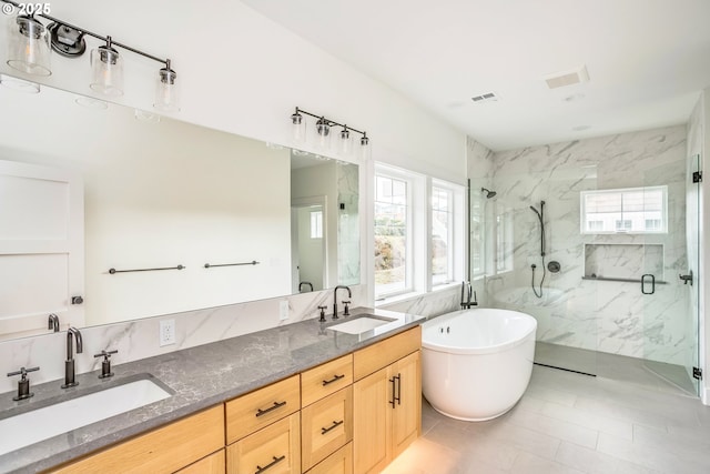 bathroom featuring vanity, a wealth of natural light, and separate shower and tub