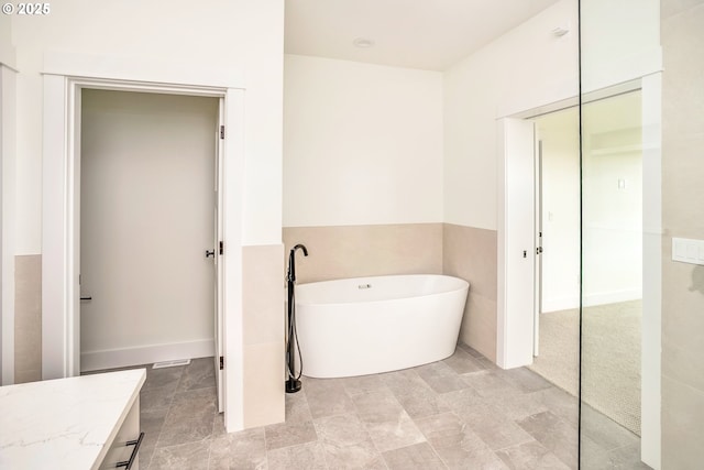 bathroom featuring vanity and a washtub