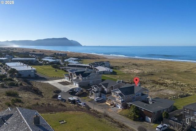 bird's eye view featuring a view of the beach and a water and mountain view