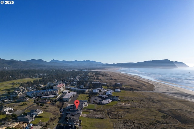 bird's eye view with a view of the beach and a water and mountain view