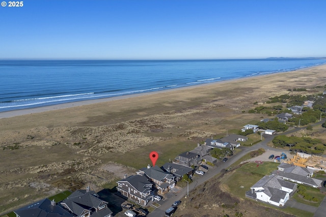 aerial view featuring a view of the beach and a water view