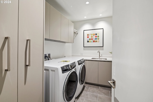 washroom with light tile patterned flooring, washing machine and dryer, recessed lighting, a sink, and cabinet space