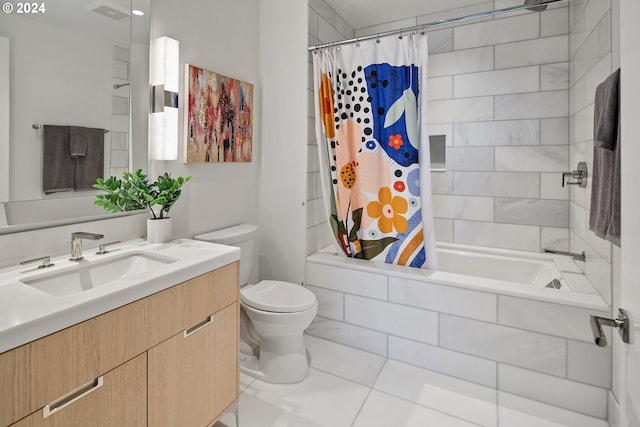 bathroom with visible vents, toilet, tiled shower / bath combo, vanity, and tile patterned floors