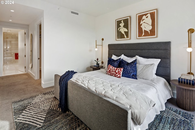 bedroom with carpet floors, recessed lighting, visible vents, ensuite bath, and baseboards