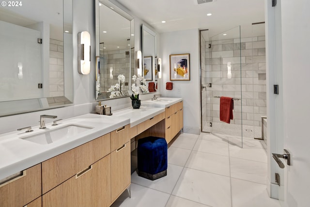 bathroom featuring double vanity, tile patterned flooring, a sink, and a shower stall