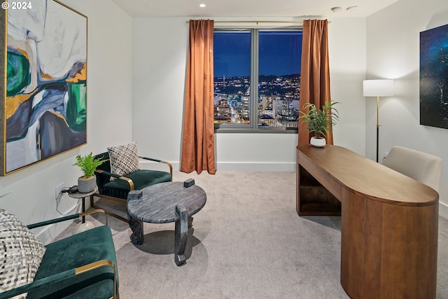 sitting room featuring carpet floors and baseboards