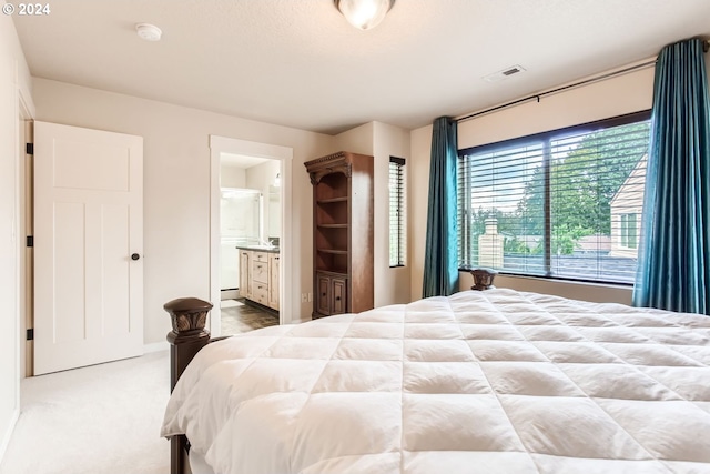 carpeted bedroom featuring connected bathroom