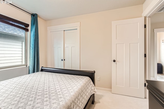 carpeted bedroom with a closet